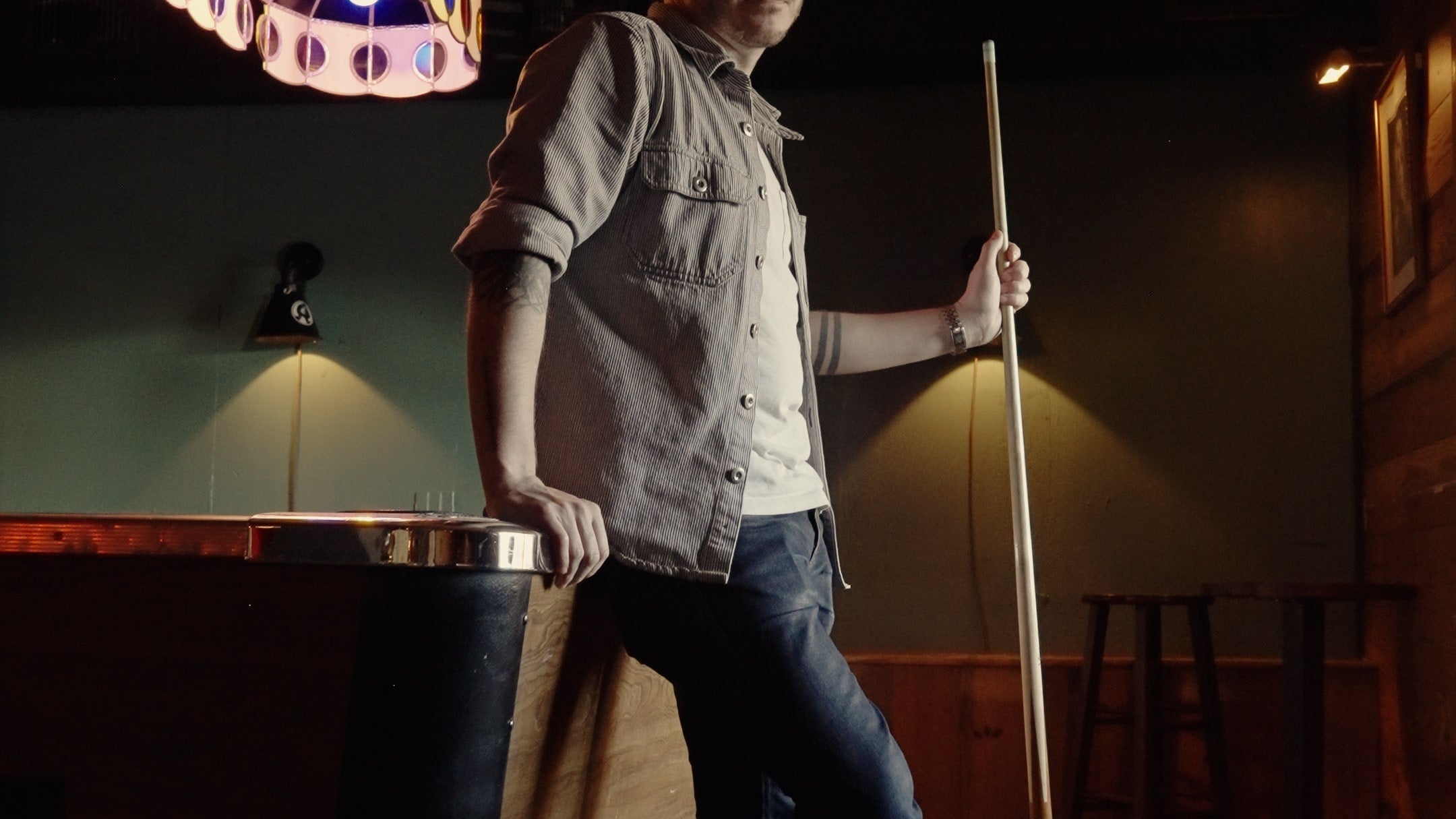 Peter Stanislaus, a man holding a pool cue wearing The Hynes Whiskey