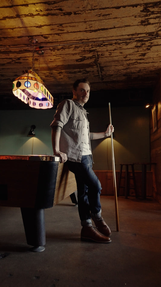 Peter Stanislaus, a man holding a pool cue wearing The Hynes Whiskey