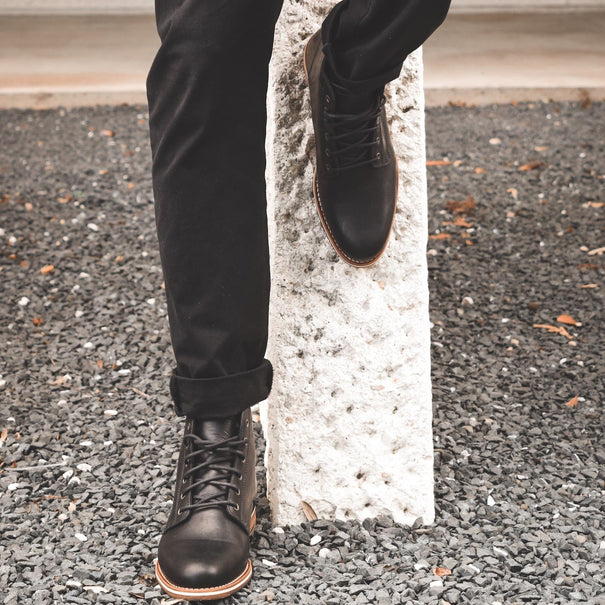 HELM - Man wearing Zind Black standing on gravel