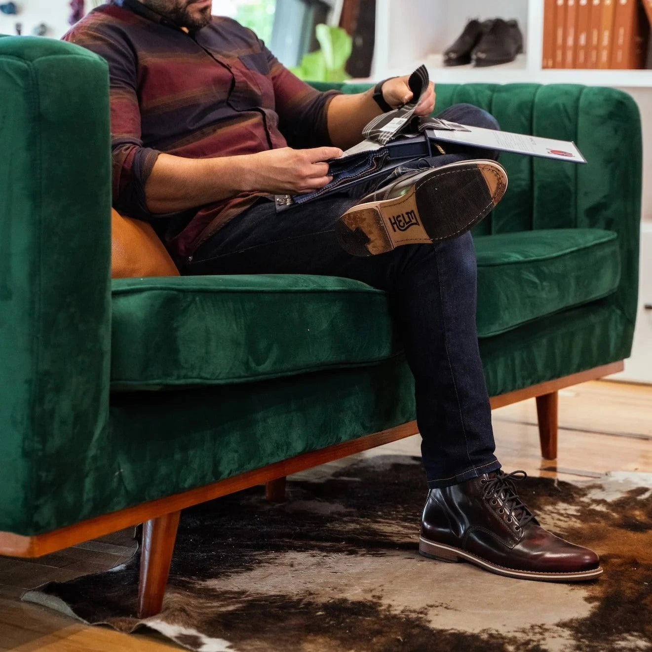 HELM - Man wearing Zind Burgundy lounging on couch